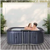 mSpa Whirlpool aufblasbar Urban Nest U-NE021 für 2 Personen mit Rattan-Tisch, aufblasbares Aufstellbecken, (Outdoor Indoor Luxus Garten Pool - inkl. Wärmeschutzabdeckung - UV-C Filter - 40 ° C Schnellheizsystem - Winterfest, Sitzpolster - 6-Schicht-P